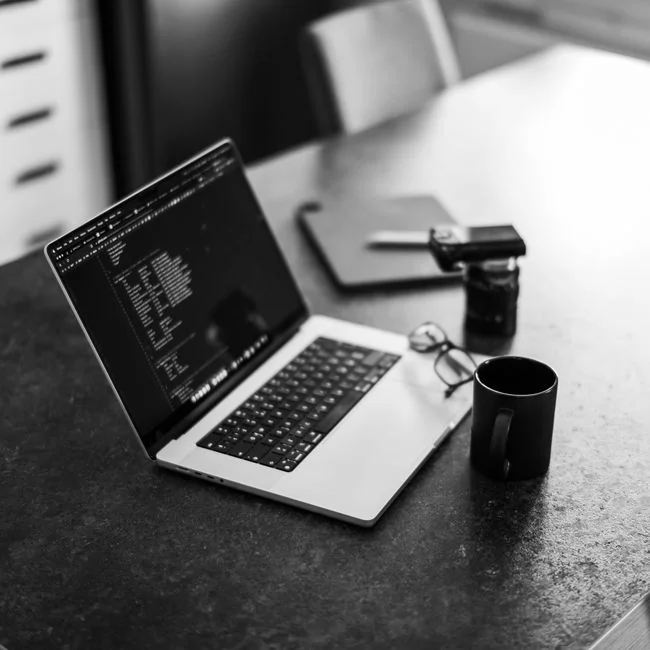 High-angle view of a sleek workspace with dual monitors, a keyboard, a mouse, and contemporary accessories.